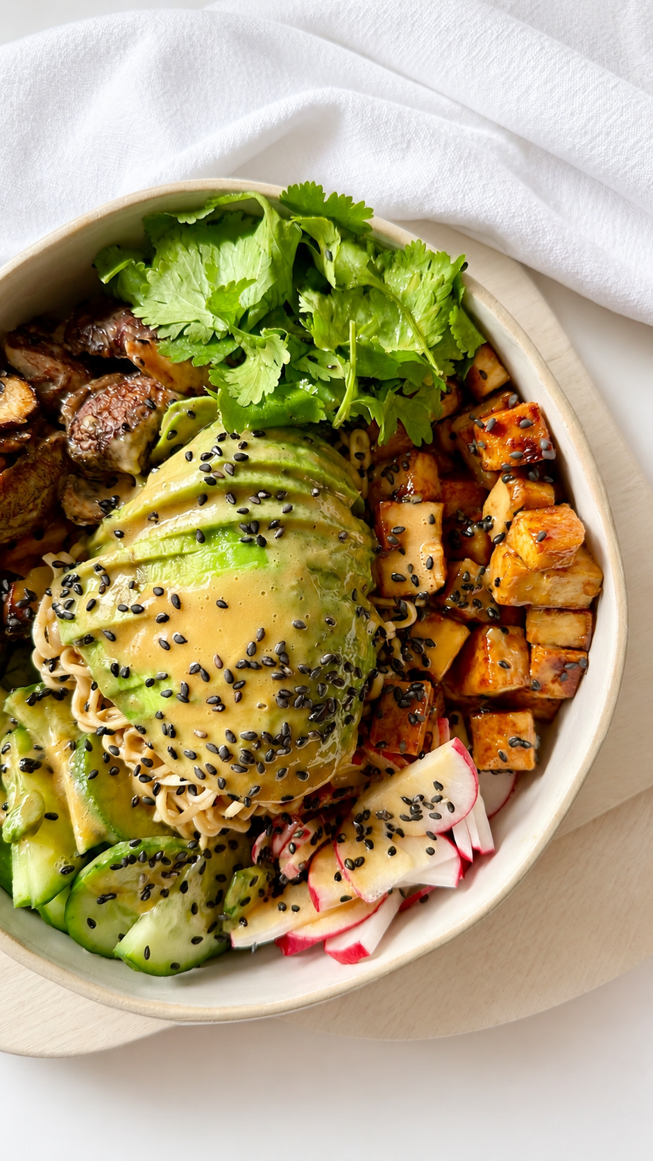 A bowl of glazed sesame tofu over rice